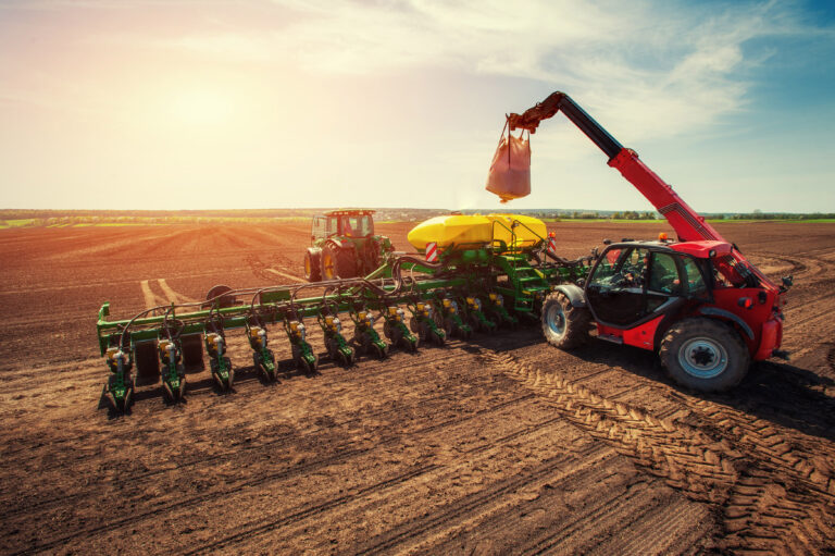 Tractor plowing farm field in preparation for spring planting